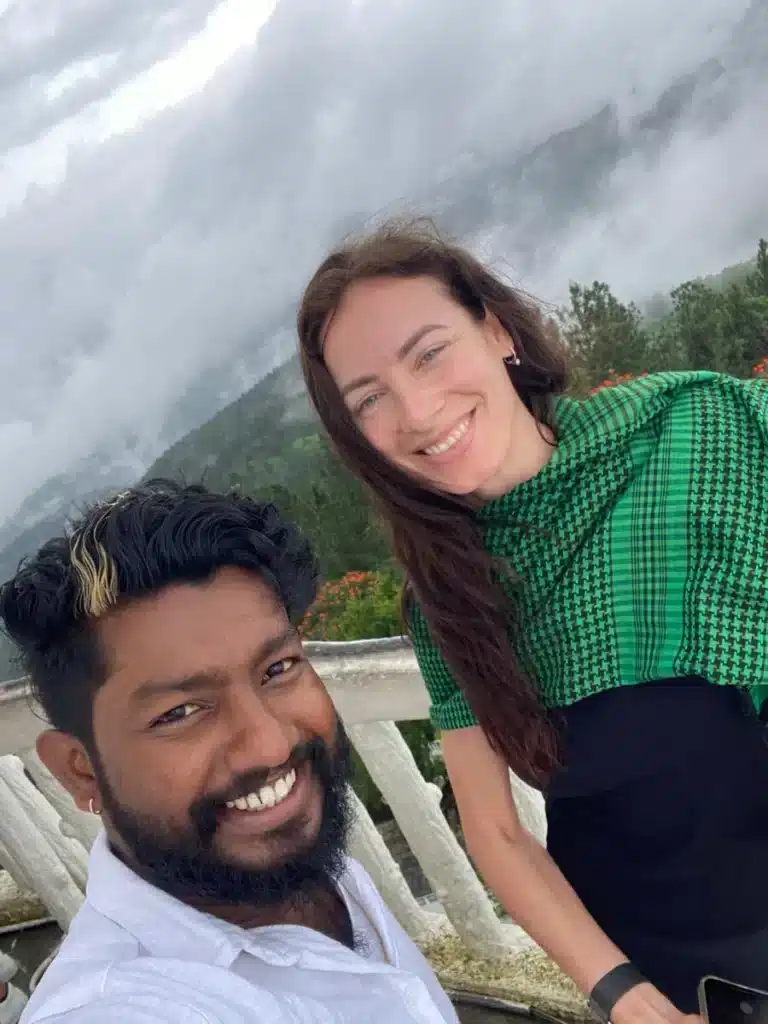 Two people taking a selfie at a misty viewpoint in the hill country