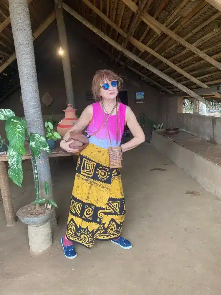 Traveller holding a clay water pot during a village visit in Sri Lanka