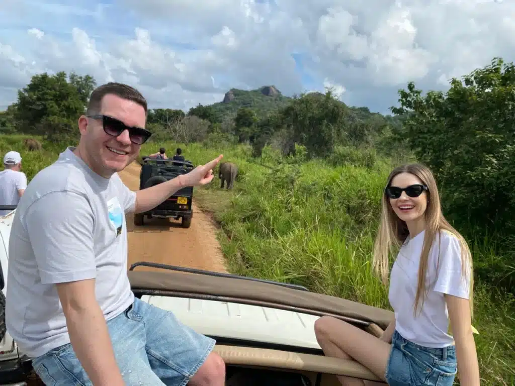 A guest in an open jeep watching elephants in Yala National Park