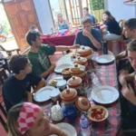 Group of travellers sharing a Sri Lankan rice and curry meal after a village cooking class