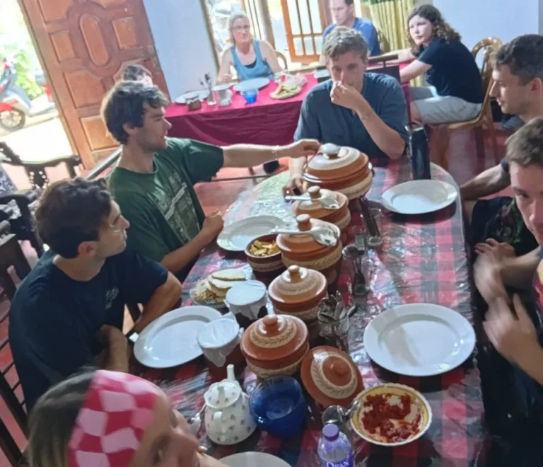 Group of travellers sharing a Sri Lankan rice and curry meal after a village cooking class